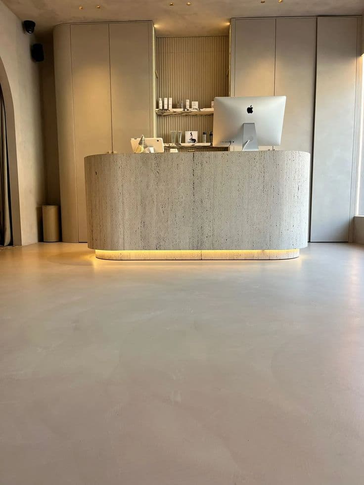 Antimicrobial Microcement Flooring for Riyadh Clinics Seamless, sterile white Microcement Flooring in a medical clinic corridor, featuring a smooth hygienic surface, installation by Floroz KSA.